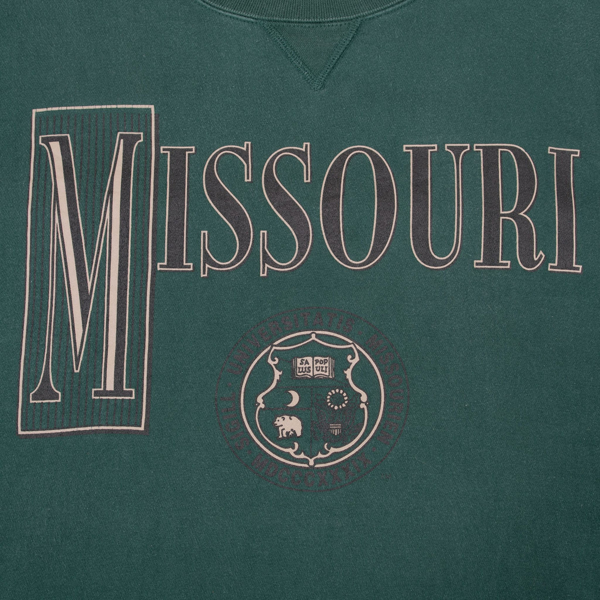 Close-up of the outlined Missouri block M and university seal front graphic