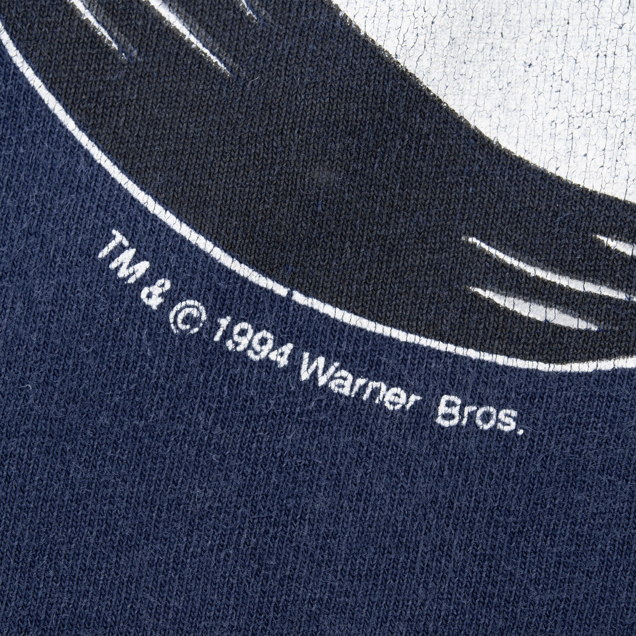 Close-up of 1994 Warner Bros. copyright text beneath the Looney Tunes print