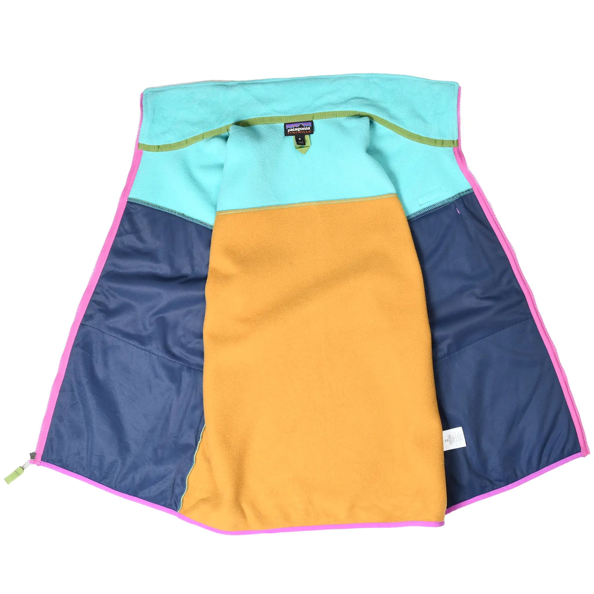 Open interior of Patagonia fleece vest showing navy pocket linings and turquoise and tan panels