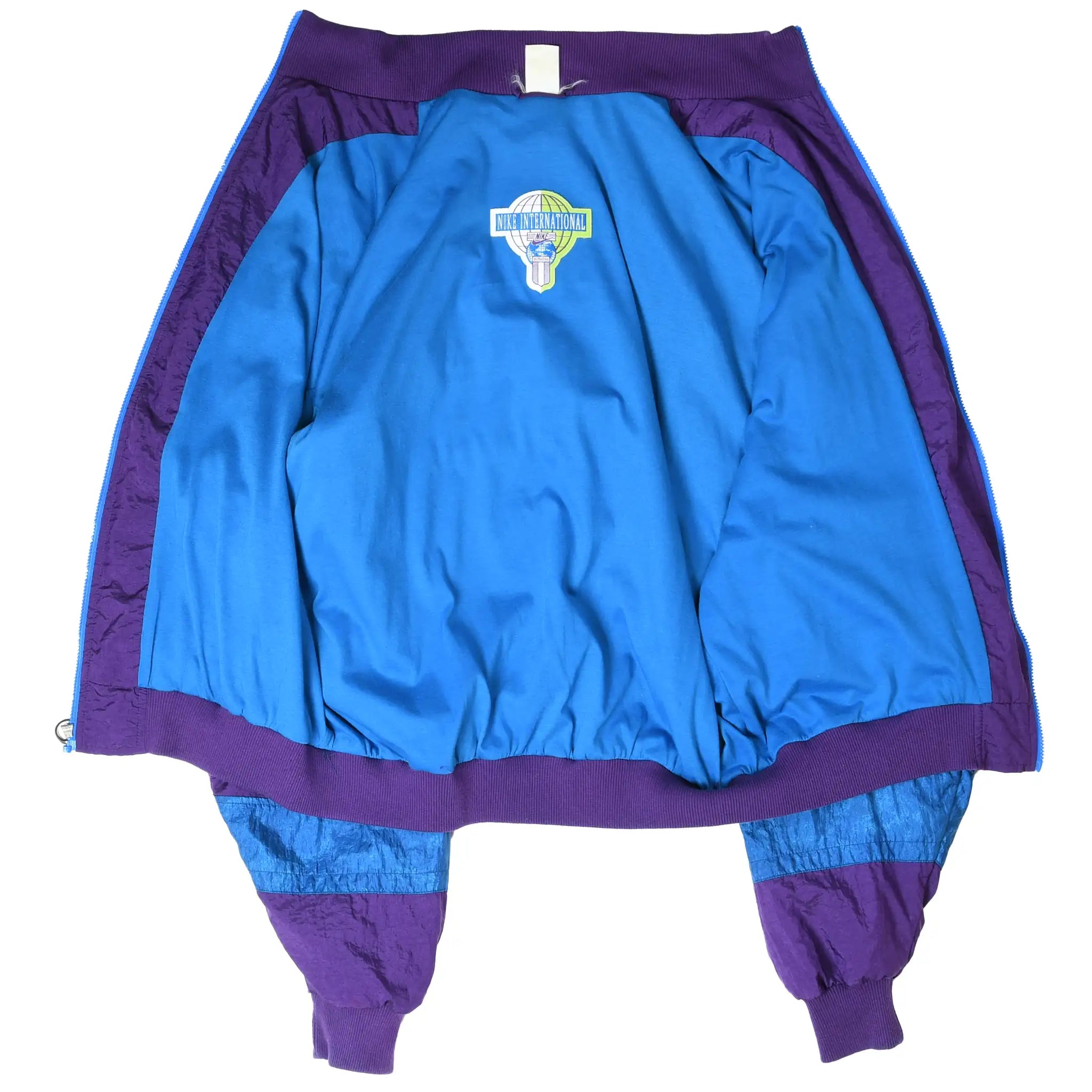 Open Nike International windbreaker showing blue interior lining and logo patch