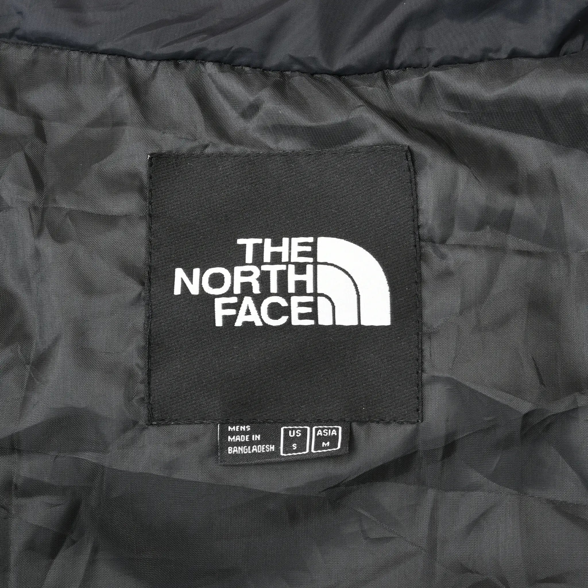 Interior The North Face neck label with men's US size small marking