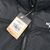 Close-up of The North Face Nuptse jacket hangtag showing model and color details