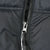 Close-up of front zipper and black shell fabric on The North Face Nuptse jacket