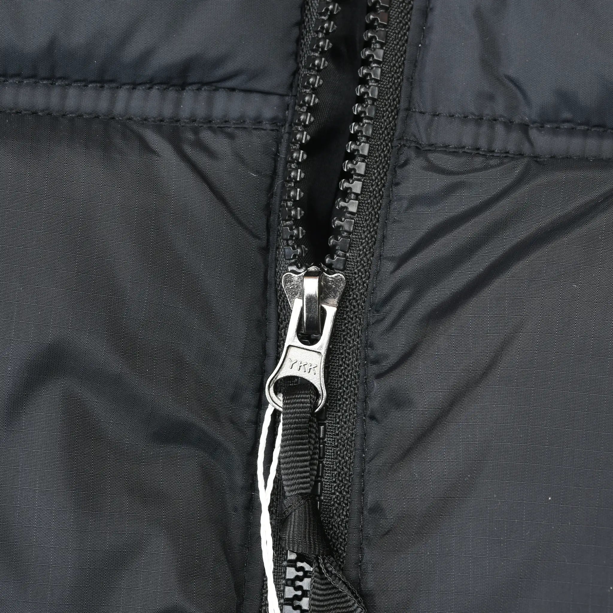Close-up of front zipper and black shell fabric on The North Face Nuptse jacket