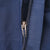 Close-up of navy blue Patagonia jacket zipper and fabric