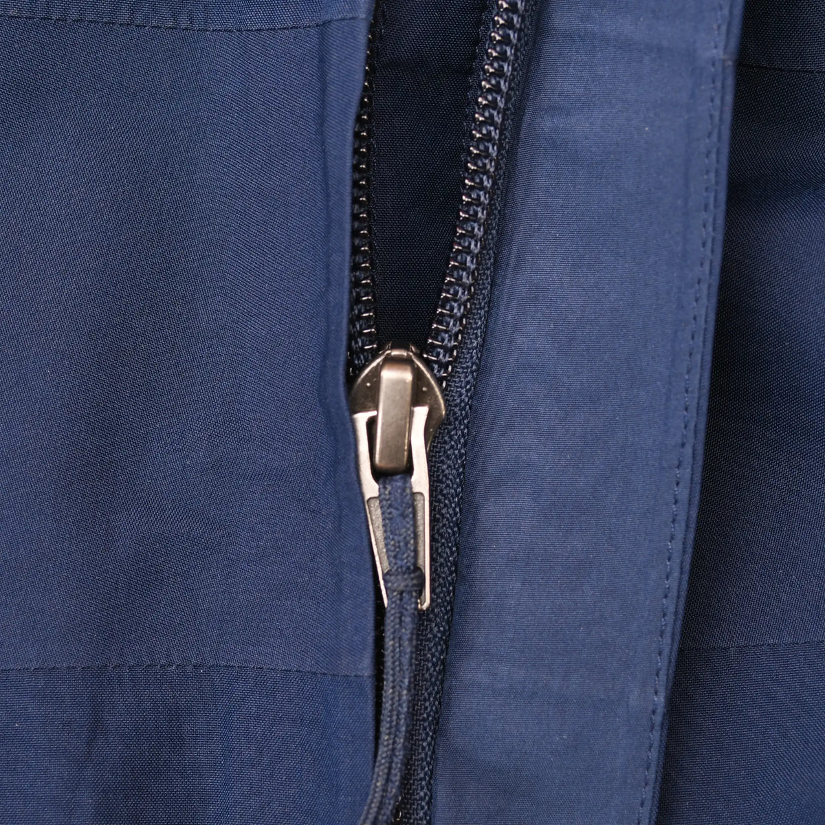 Close-up of navy blue Patagonia jacket zipper and fabric
