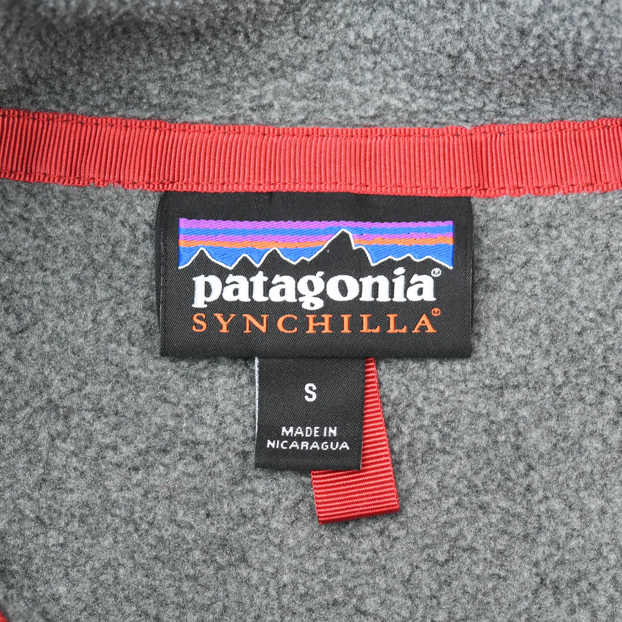 Patagonia Synchilla neck label and small size tag inside grey fleece