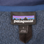Patagonia neck label and large size tag inside blue fleece jacket