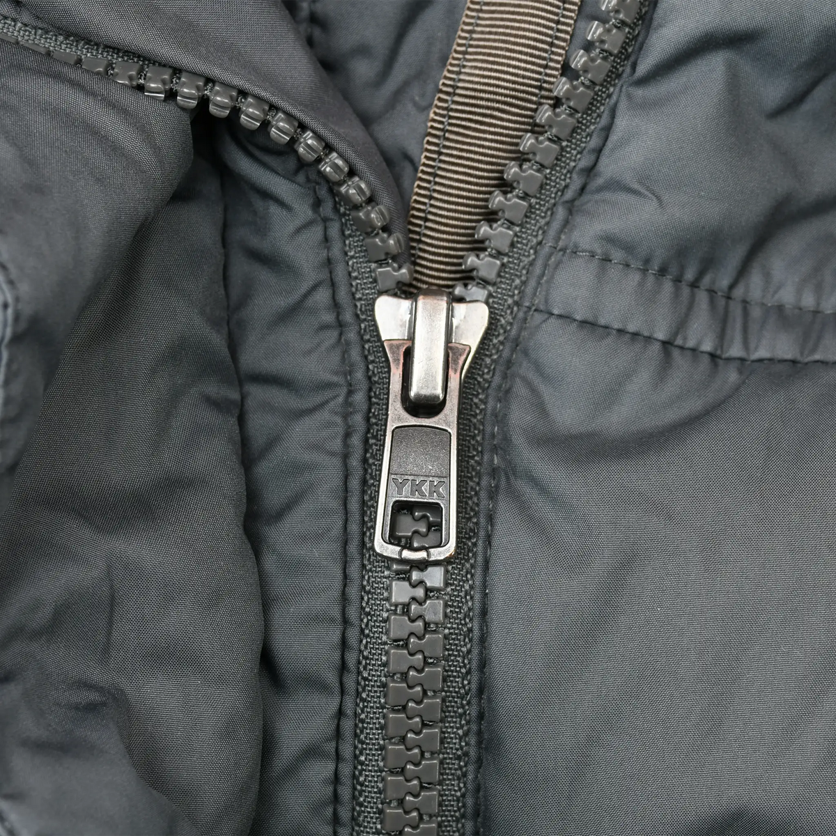 Close-up of gray Patagonia parka YKK front zipper