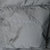 Close-up of Patagonia logo embroidery on gray parka fabric