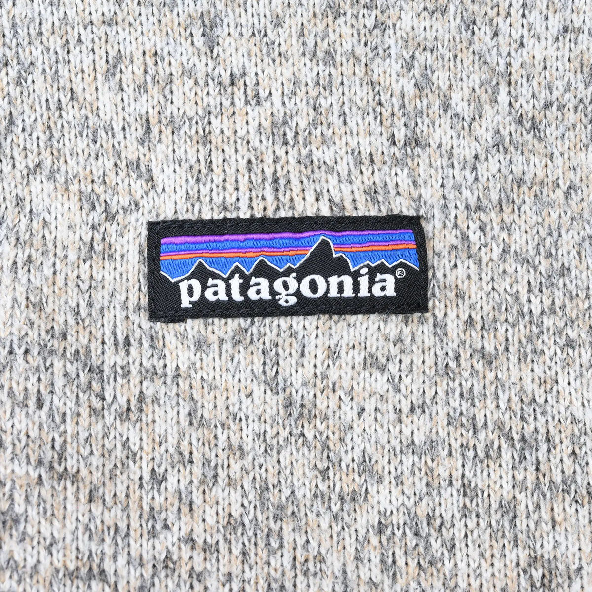 Close-up of Patagonia logo patch on beige heather fleece