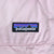 Patagonia woven logo patch on pale pink puffer fabric