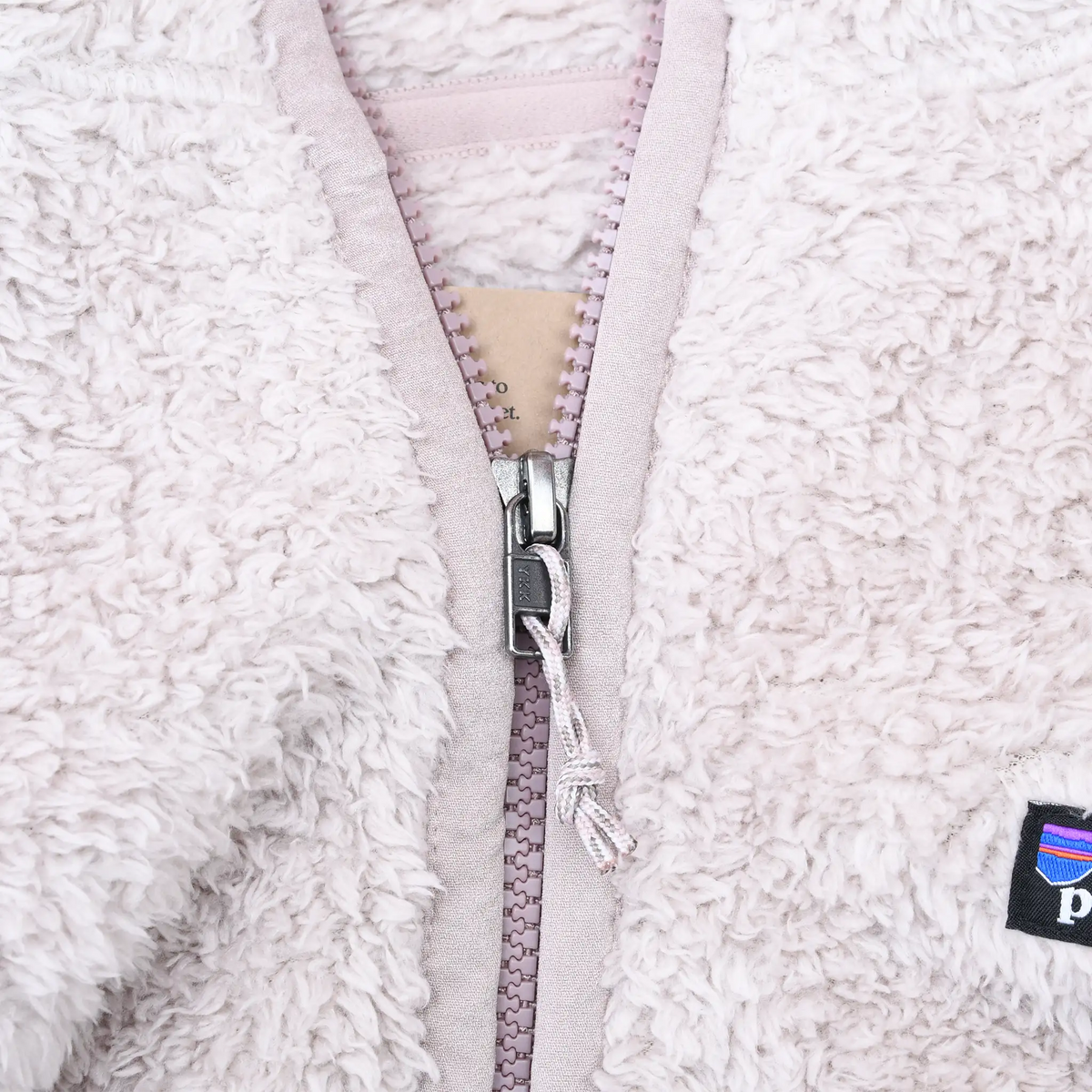 Close-up of quarter-zip closure and plush fleece texture