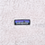 Patagonia logo patch on beige plush fleece fabric