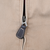 Close-up of Polo-engraved zipper and dark leather pull on brown jacket