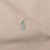 Close-up of green Polo pony embroidery on brown jacket fabric