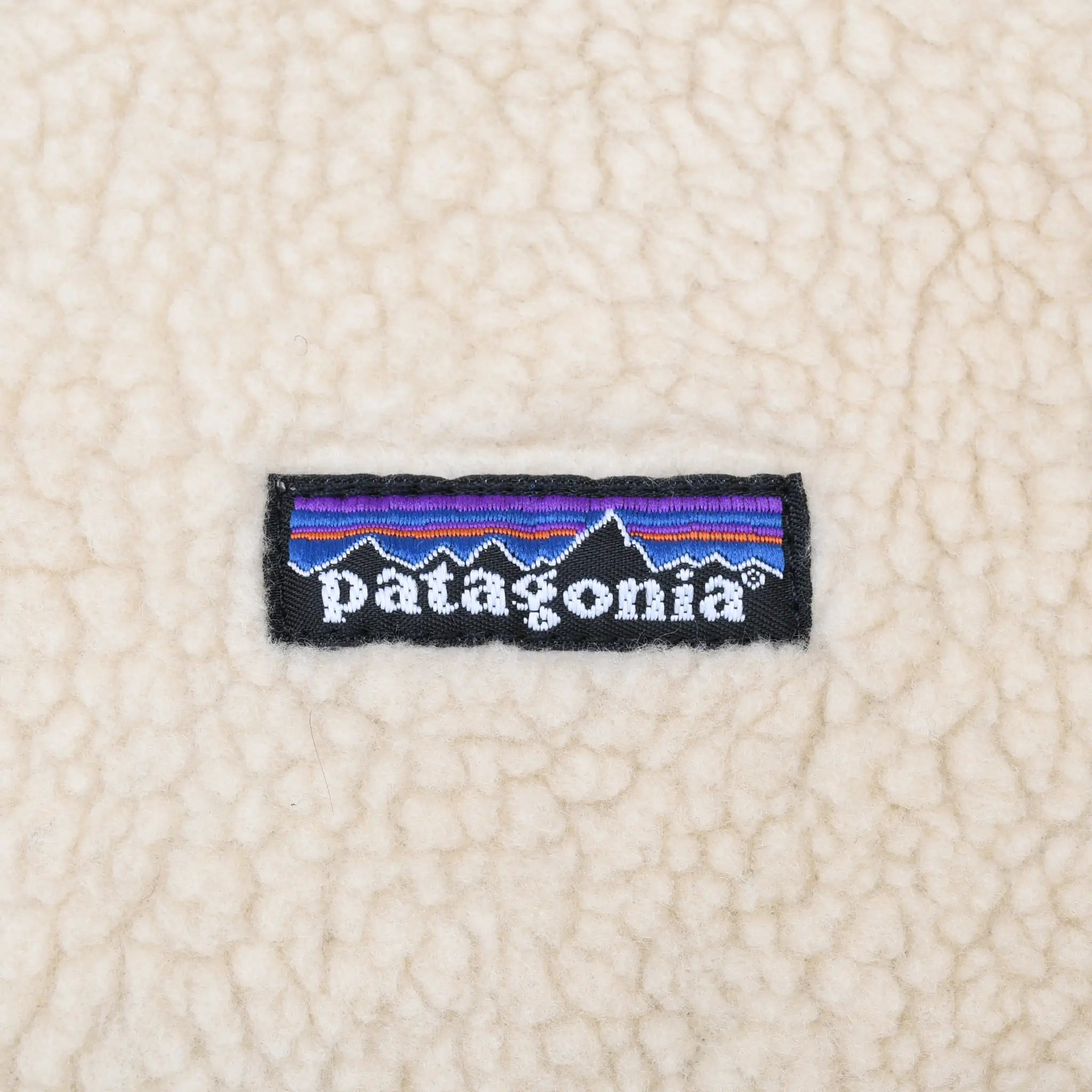 Patagonia logo patch embroidered on beige fleece