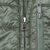 Close-up of front and chest pocket zippers on green Patagonia jacket