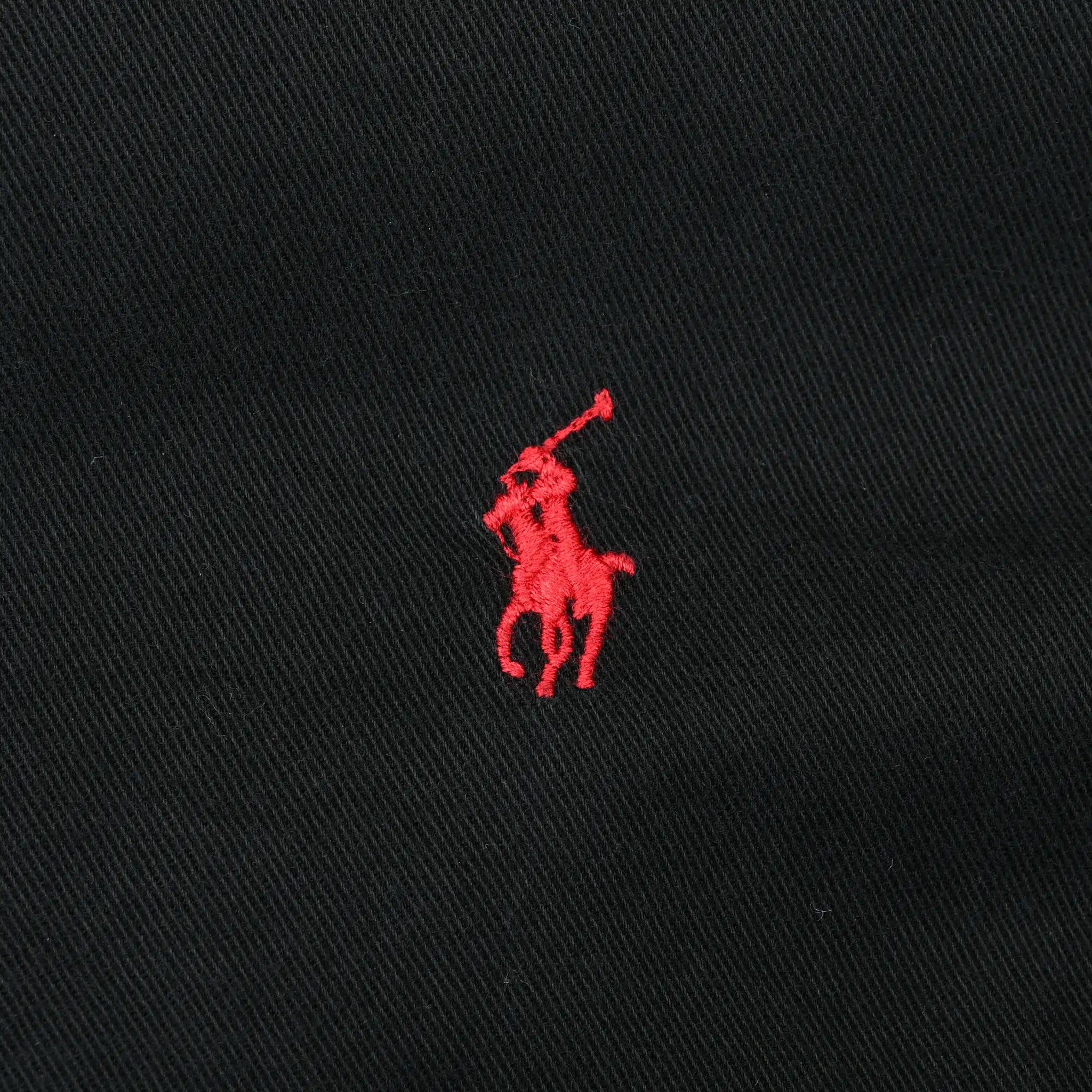 Close-up of red Ralph Lauren pony embroidery on black shirt fabric