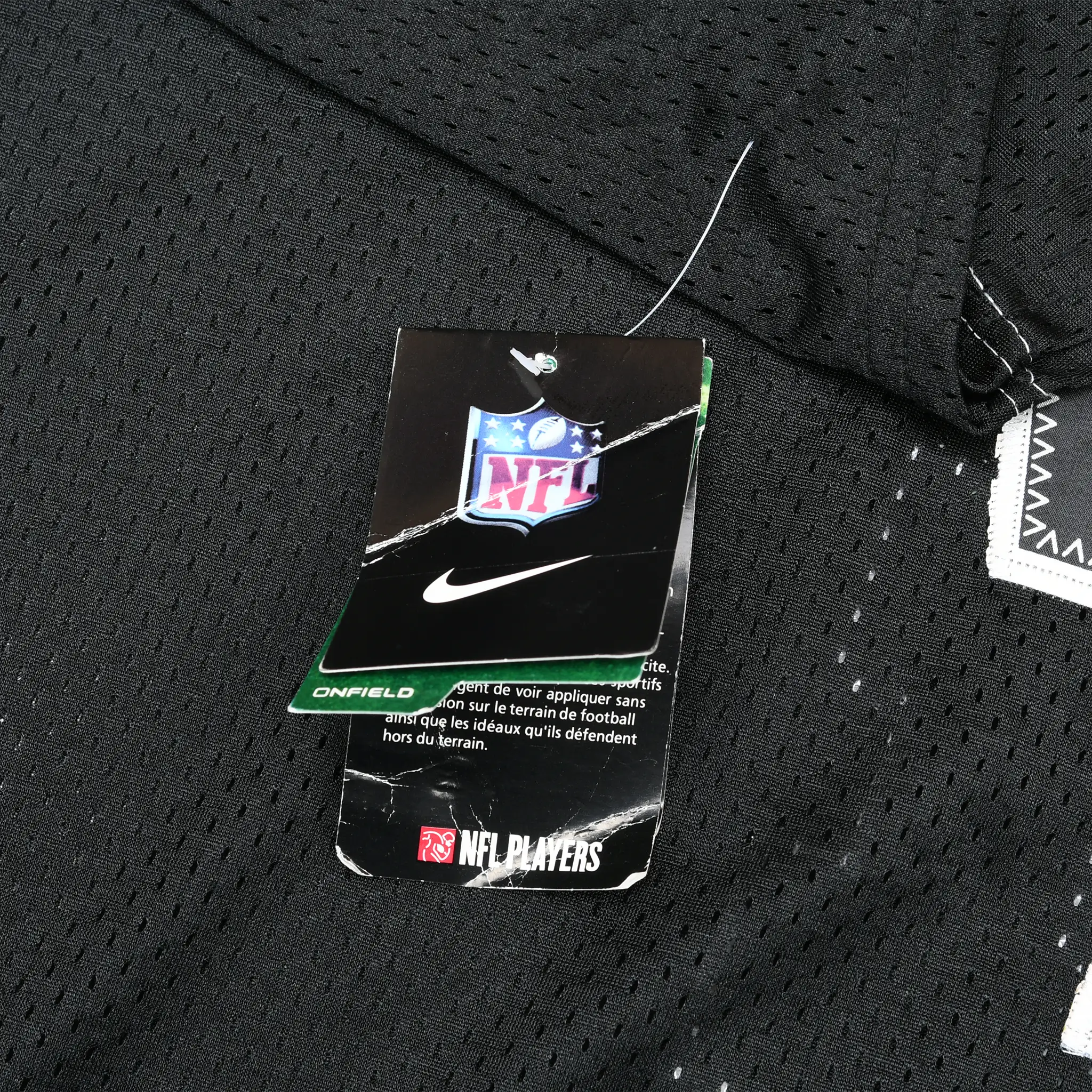 Nike NFL and NFL Players hangtags attached to black mesh jersey