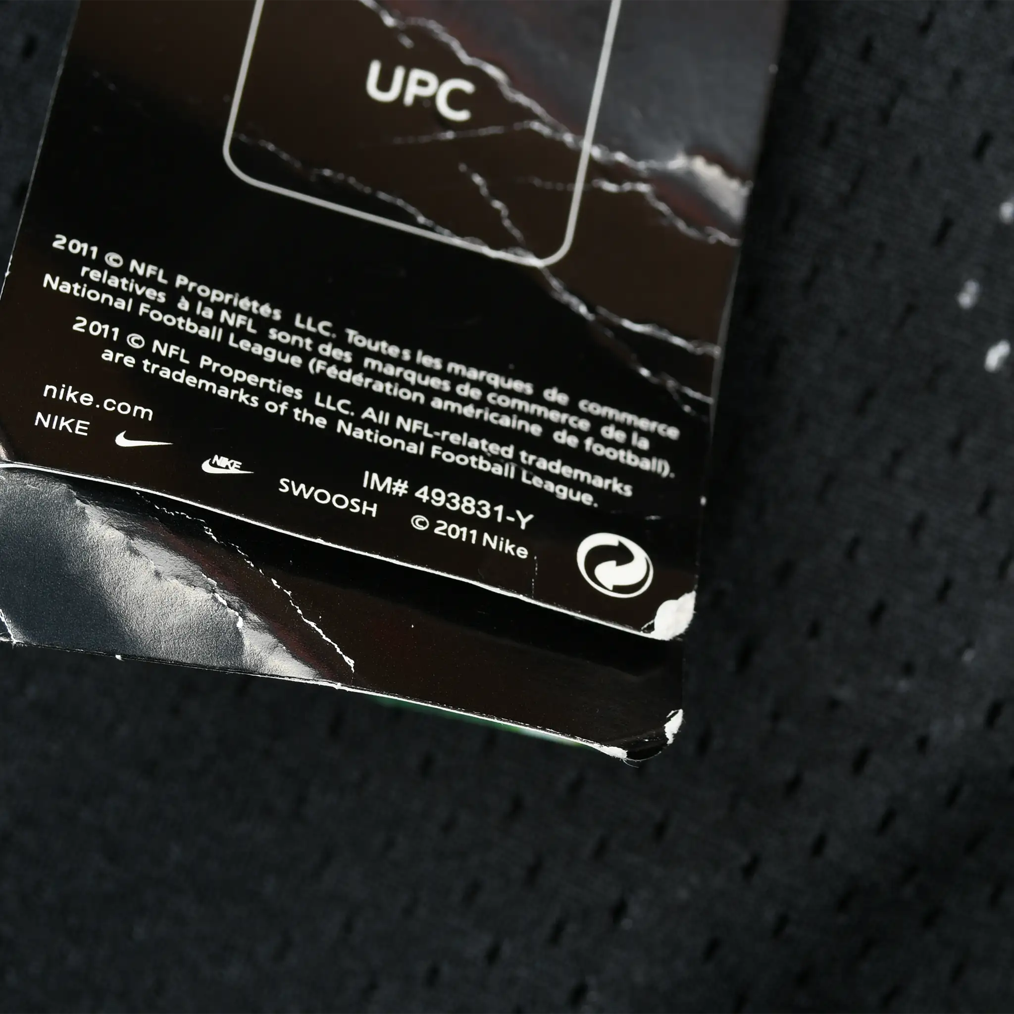 Back of Nike hangtag showing 2011 NFL licensing text and item number 493831-Y