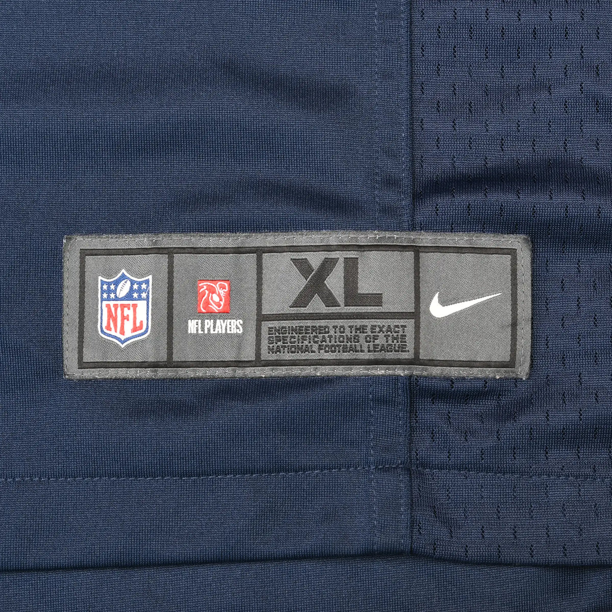 Nike NFL jersey hem label marked XL on navy fabric