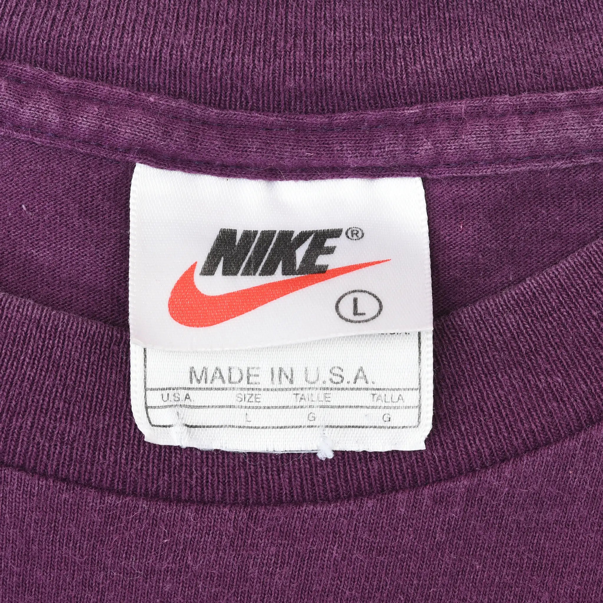 Nike neck tag with Swoosh logo, size L and Made in USA text