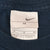 Nike neck tag showing Swoosh logo and medium size marking