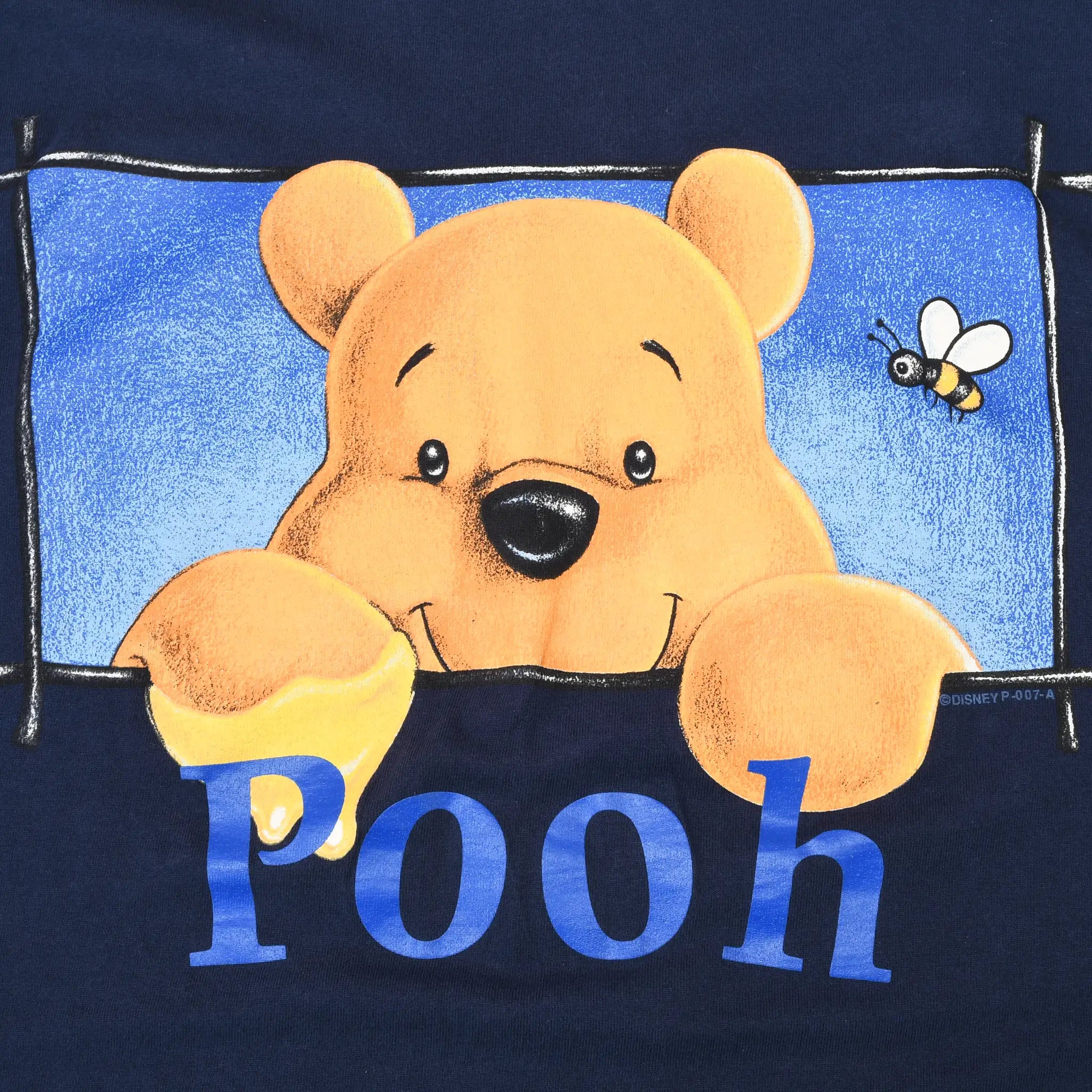 Close-up of Winnie the Pooh and bee front graphic with blue Pooh lettering