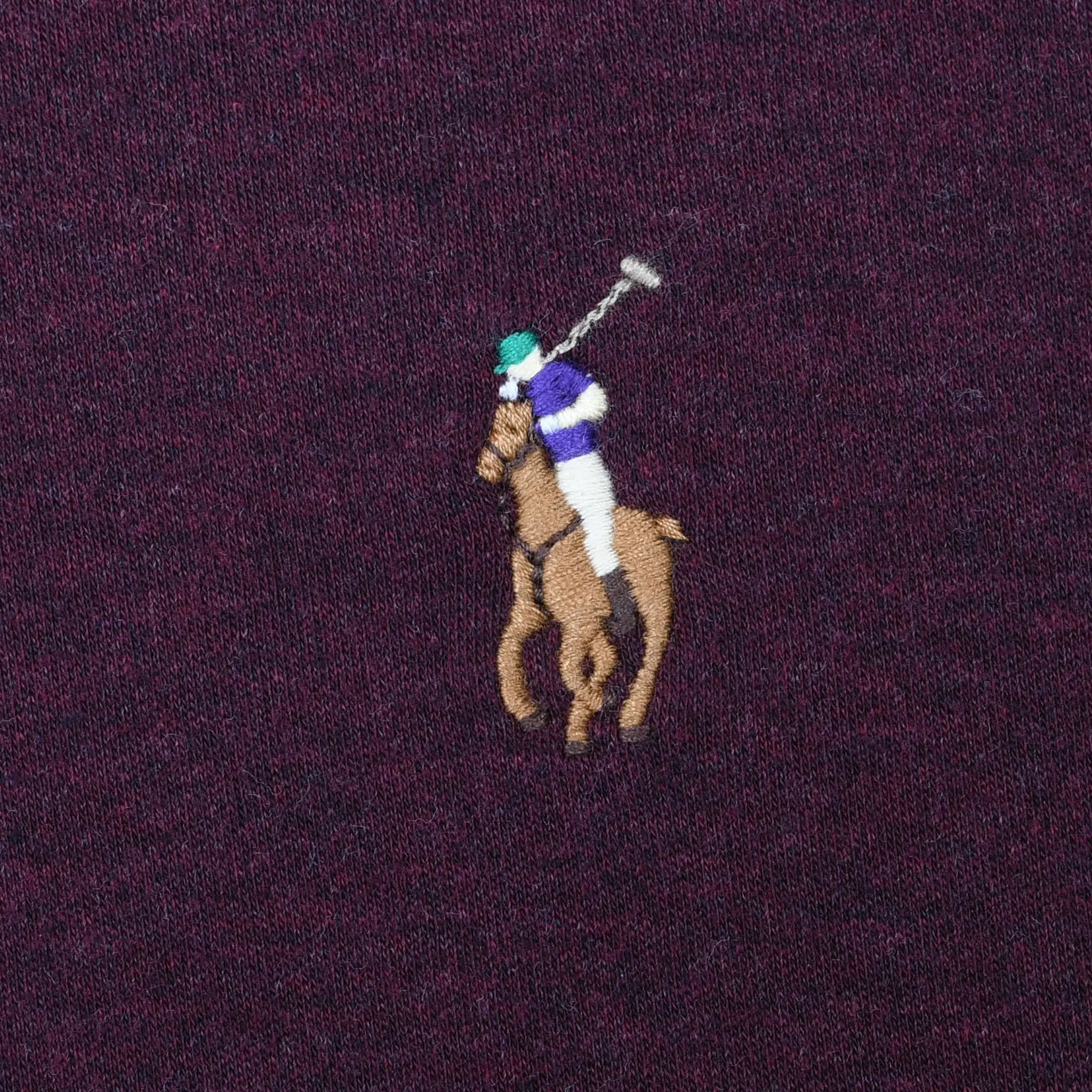 Close-up of Polo Ralph Lauren multicolor pony embroidery on burgundy fabric