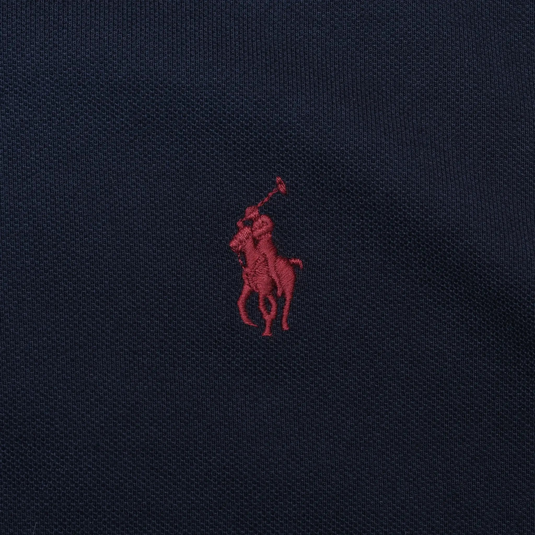 Close-up of red Polo Ralph Lauren pony embroidery on navy fabric