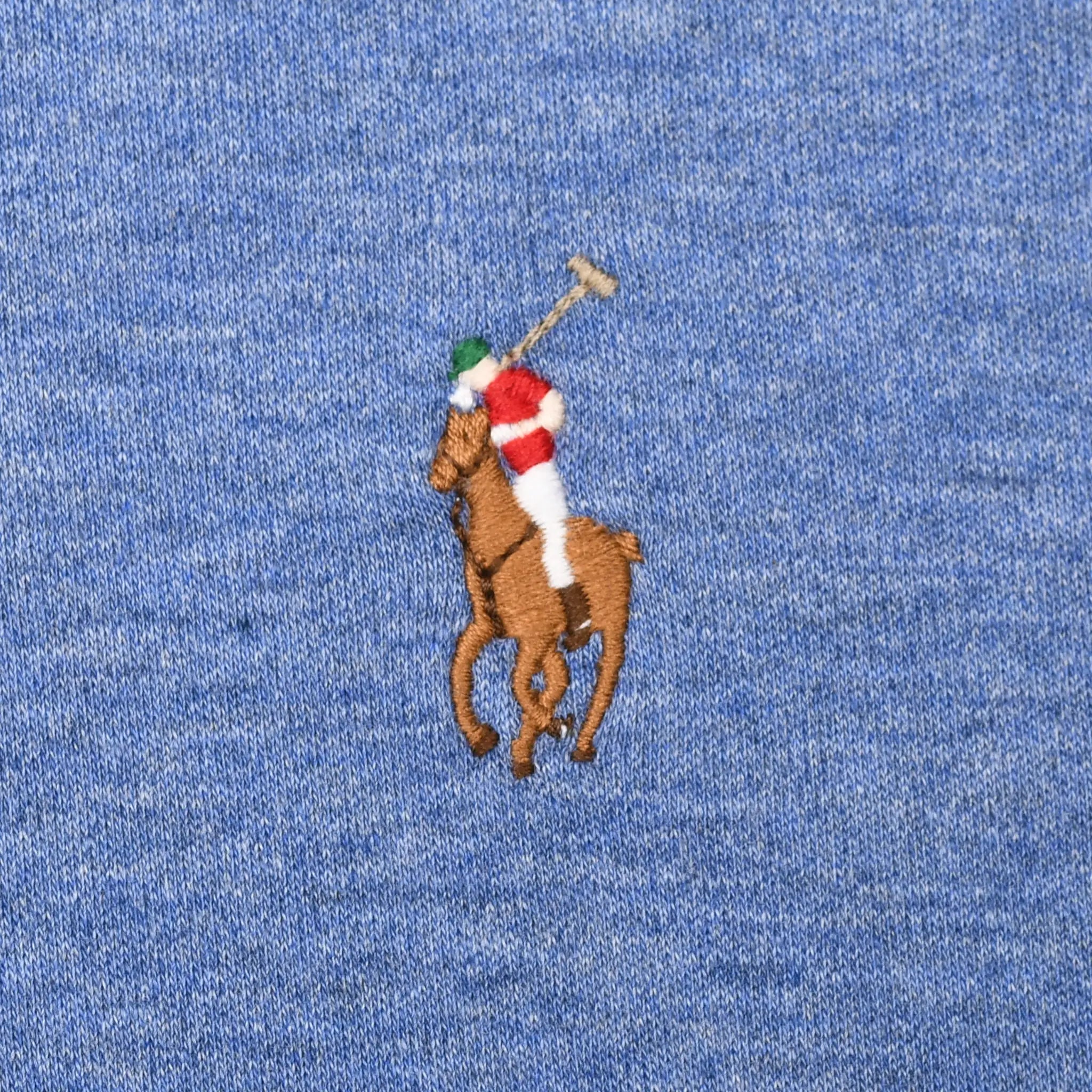 Close-up of multicolor Polo pony embroidery on blue fabric