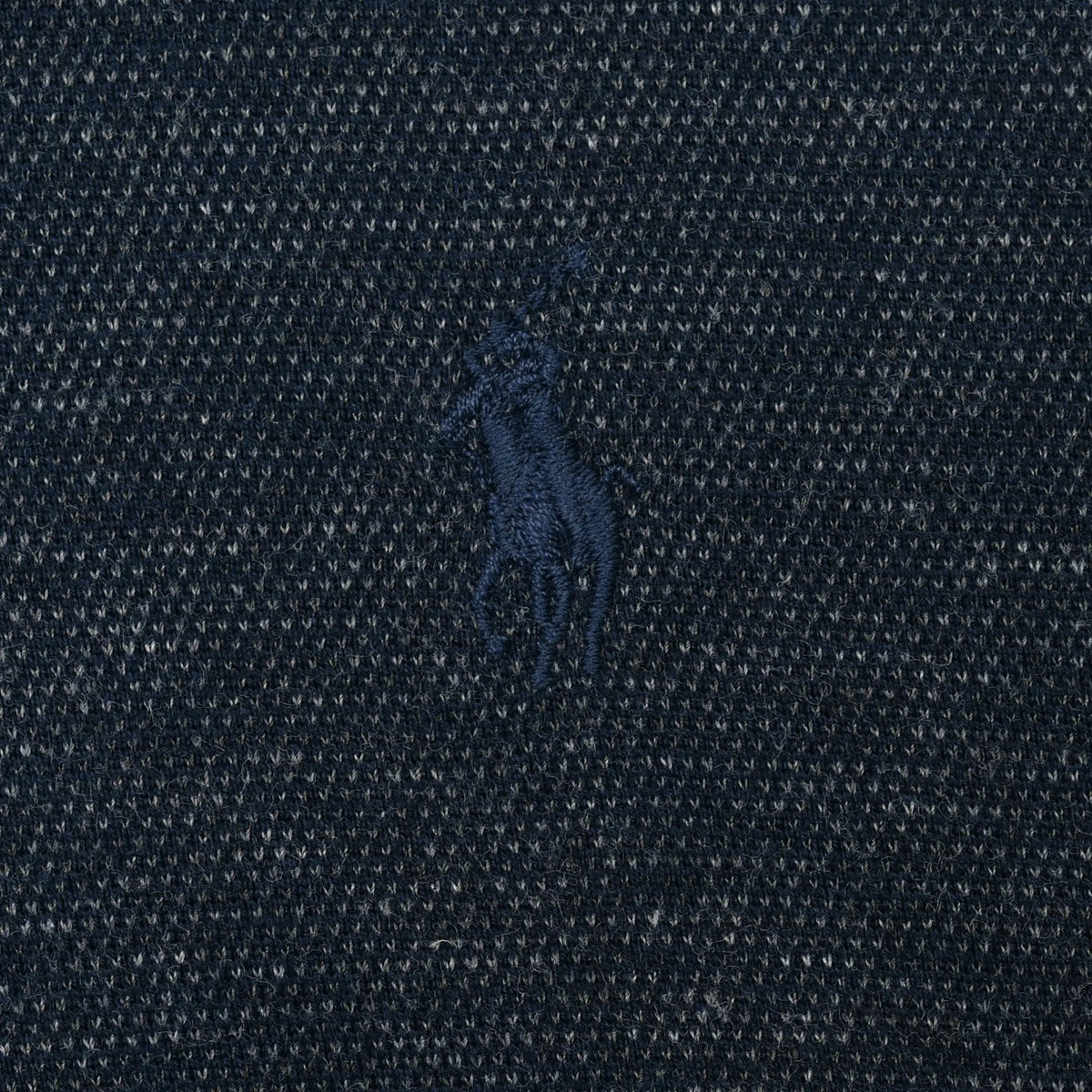 Close-up of tonal Polo pony embroidery on navy blue fabric