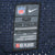 Close-up of Nike NFL On Field size 52 neck label on navy mesh jersey