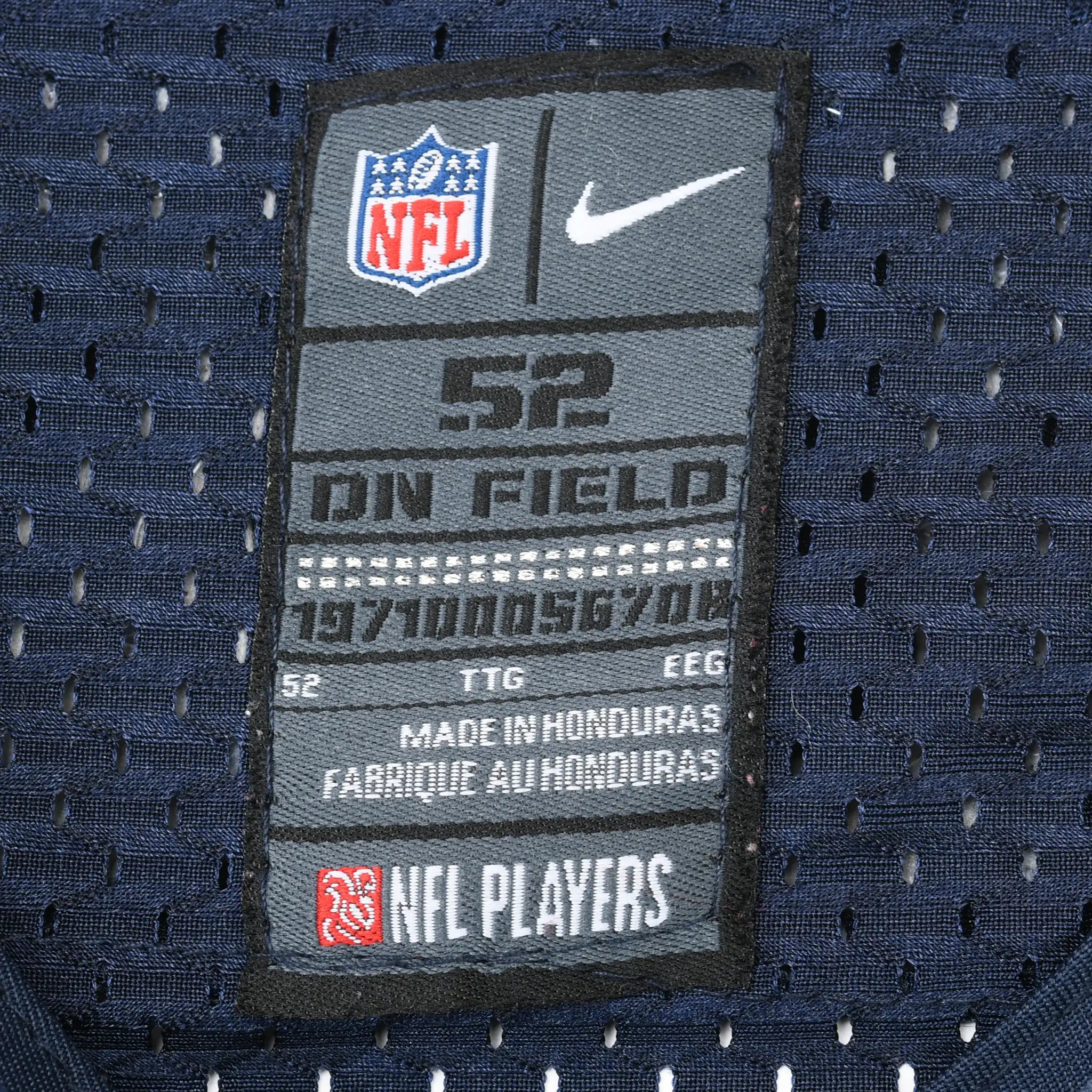 Close-up of Nike NFL On Field size 52 neck label on navy mesh jersey