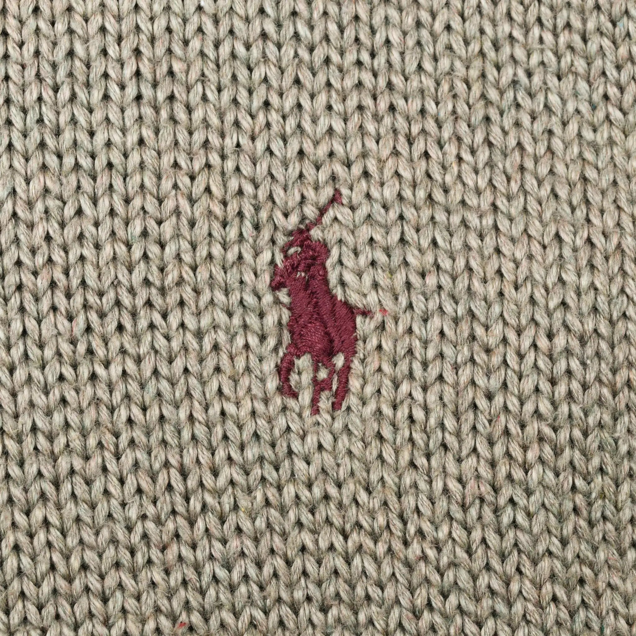 Close-up of burgundy Polo pony embroidery on sage green knit fabric