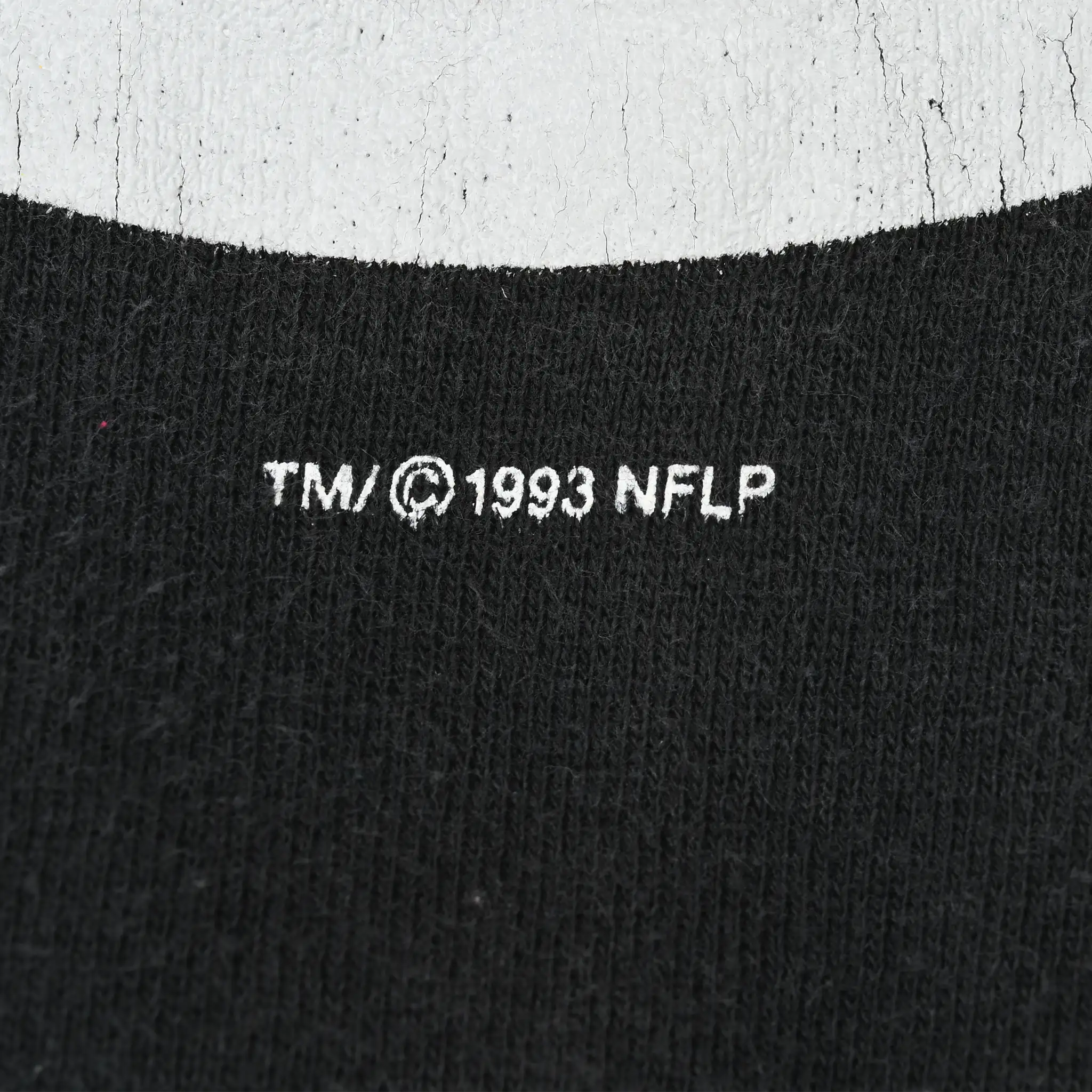 Close-up of 1993 NFLP trademark print beneath the Steelers graphic