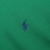 Close-up of navy Polo pony embroidery on green sweater