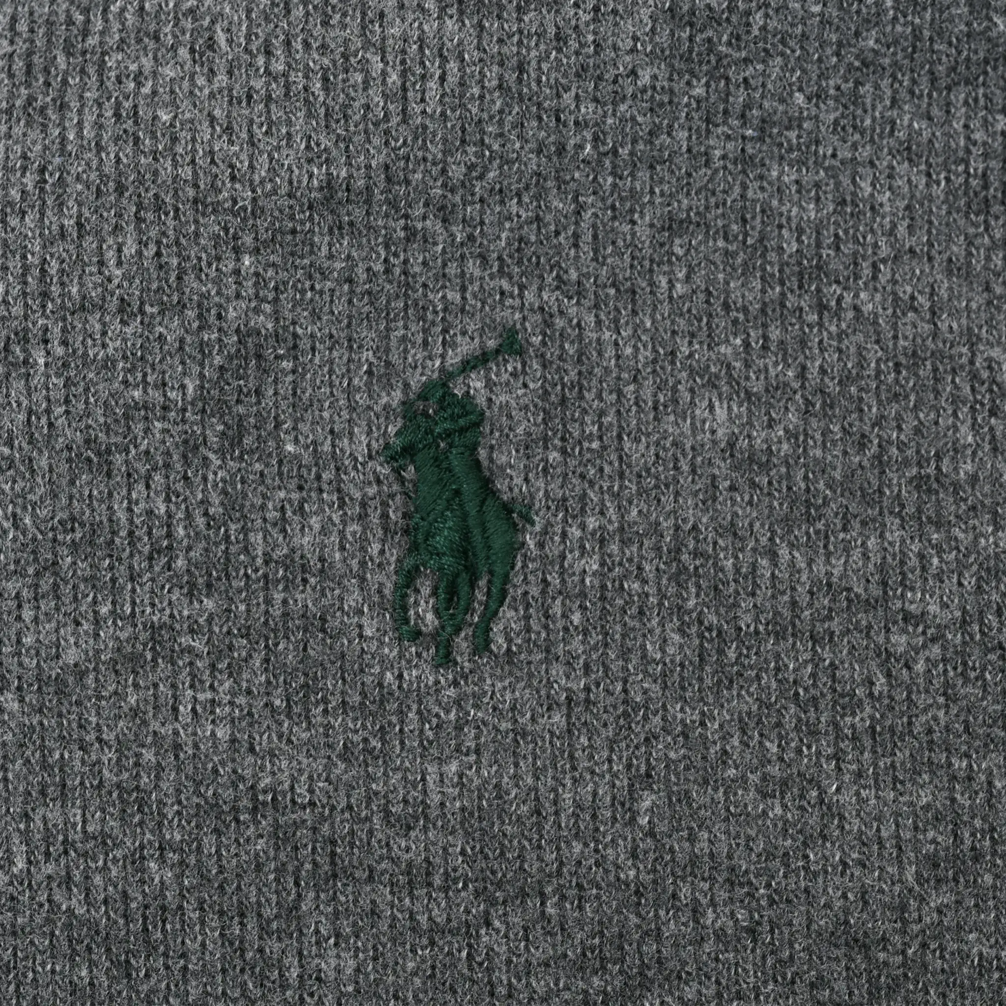 Close-up of green Polo pony embroidery on dark grey sweater