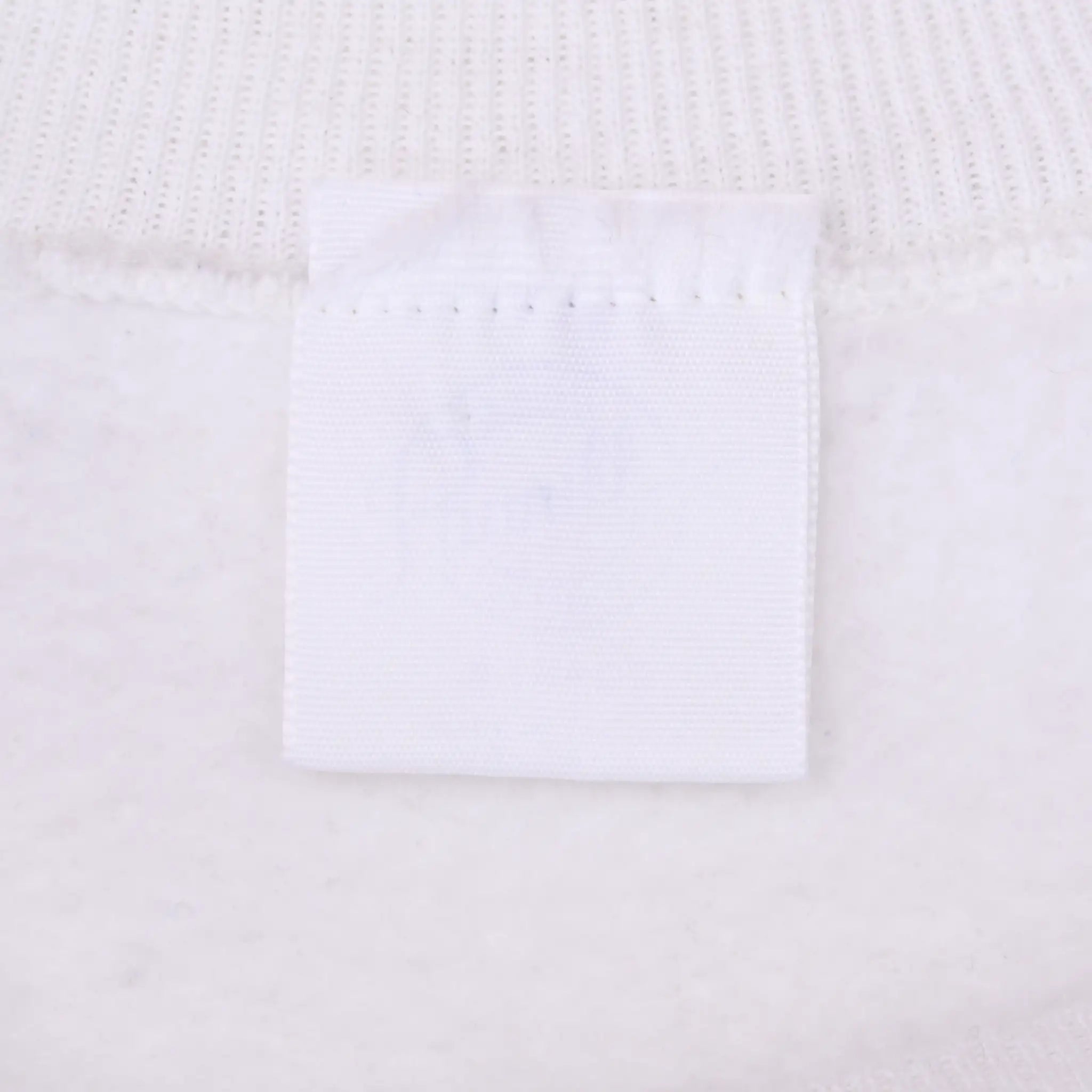 Close-up of blank white sweatshirt neck tag and collar stitching