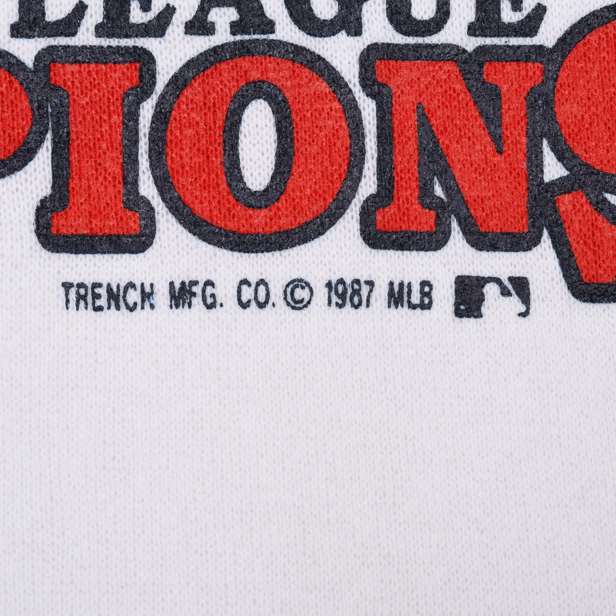Close-up of Trench Mfg. Co. 1987 MLB copyright mark beneath front print