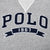 Close-up of navy and white POLO 1967 chest embroidery on grey sweatshirt