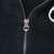 Close-up of Polo-branded metal zipper pull on black hoodie