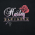 Close-up of Harley-Davidson script and red rose chest print on black fabric