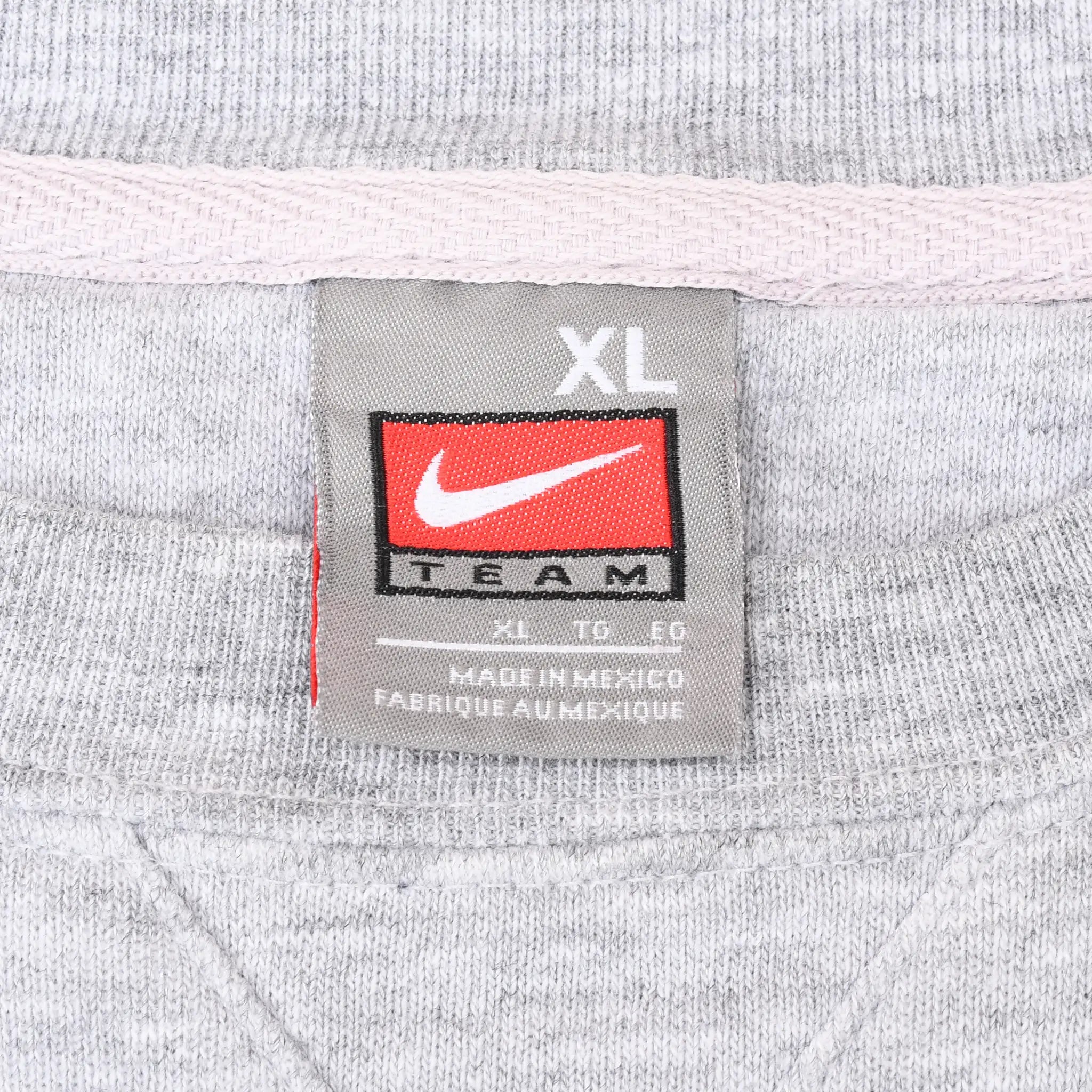 Close-up of Nike Team XL neck label inside gray sweatshirt