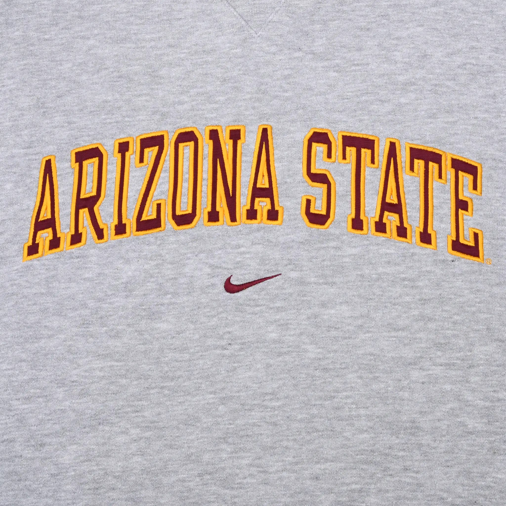 Close-up of maroon and gold Arizona State lettering with Nike Swoosh
