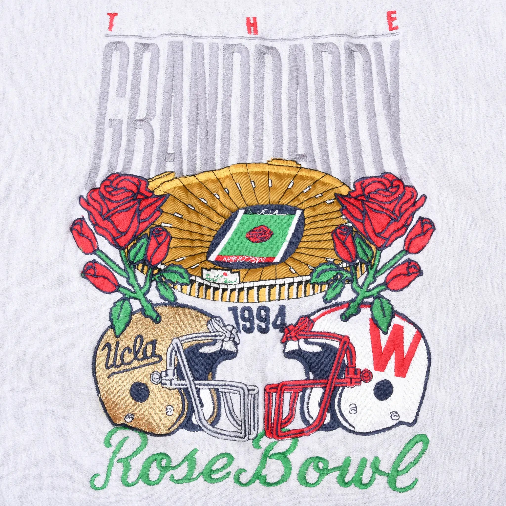Close-up of 1994 UCLA-Wisconsin Rose Bowl embroidery with helmets, roses, and stadium