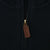 Close-up of quarter-zip closure with brown pull on black Polo Ralph Lauren sweater