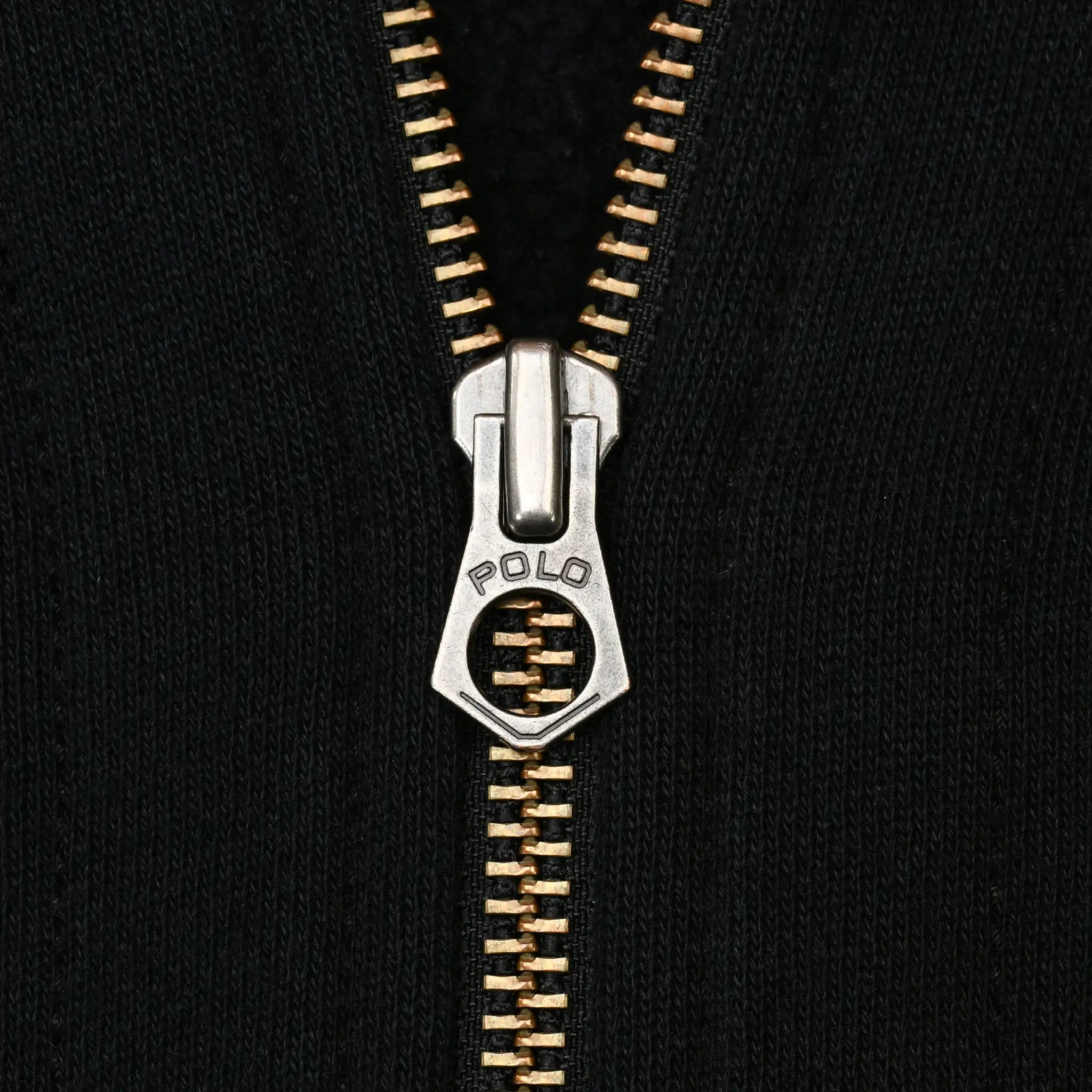 Close-up of metal zipper and Polo-engraved pull on black hoodie