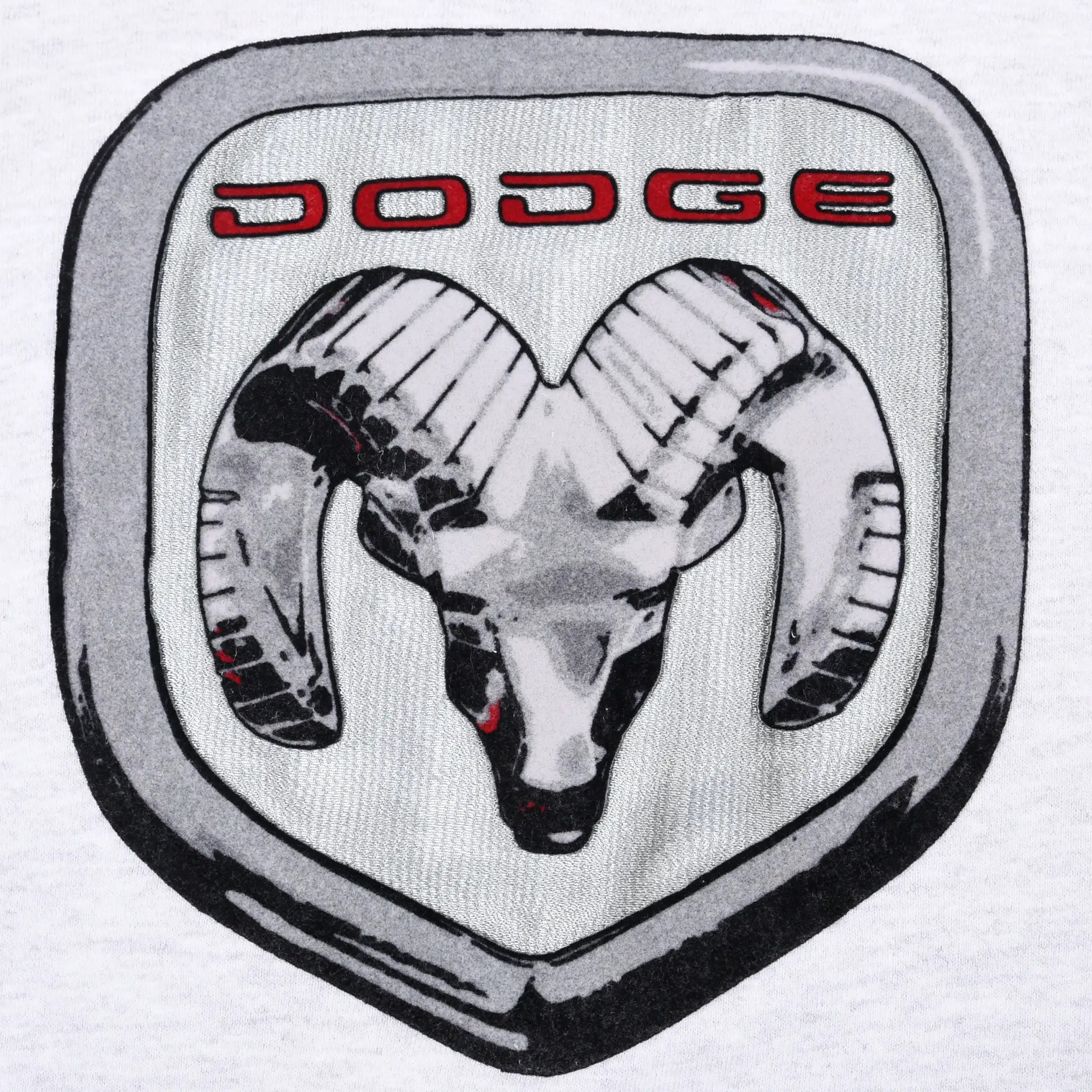 Close-up of silver, black, and red Dodge ram logo patch